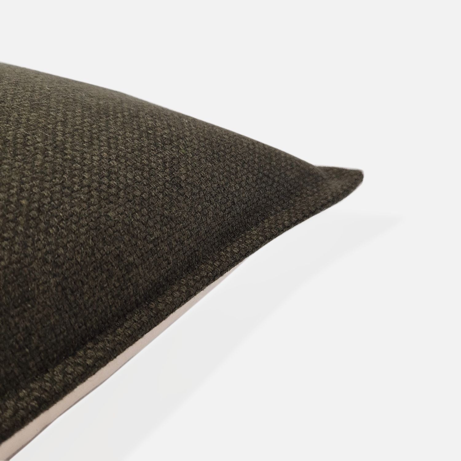Close-up detail of the Amano Olive dark green woven fabric, showing the high-quality wool-blend texture and durable craftsmanship of the textured cushion cover by decorative threads nz.