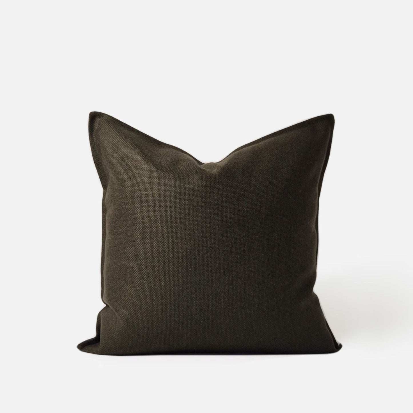 Olive green cushion cover in a textured woven wool blend. This dark green decorative pillow cover is ideal for luxury home decor and modern sofa styling.
