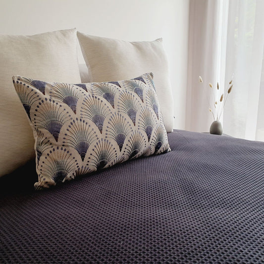 Amelie & Fanciful cushion covers, styled on a bedroom with a black textured duvet