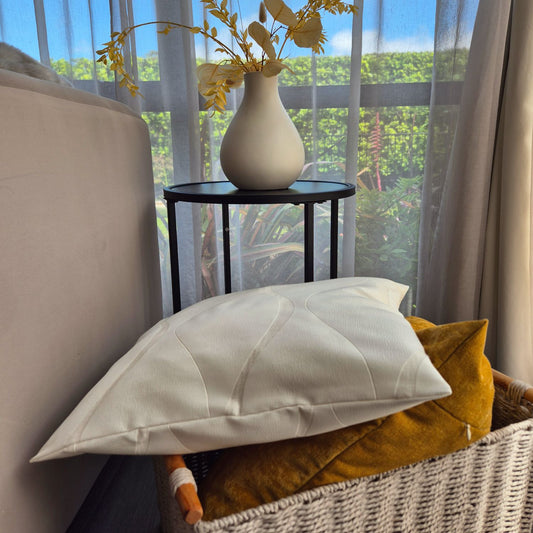 Aspen and ember cushion covers in a basket by a sofa and window