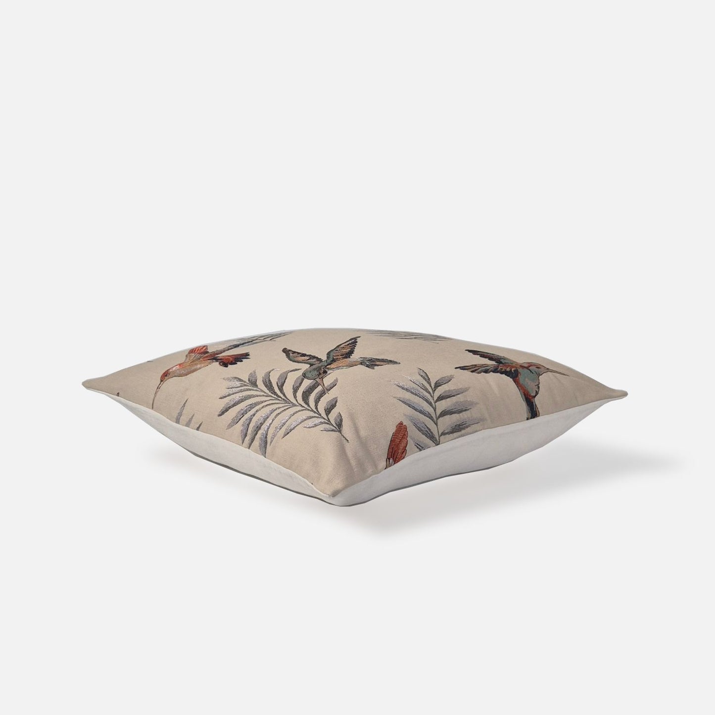 Aerial top-down view of the Avian Multi-Embroidered cushion cover showcasing the detailed botanical pattern of bird and leaf embroidery layout.