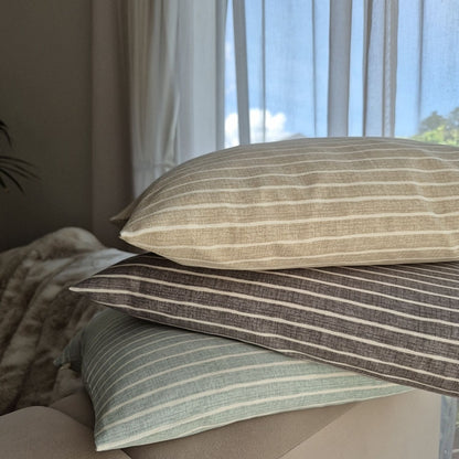azure cushion covers piled on a sofa in a living room