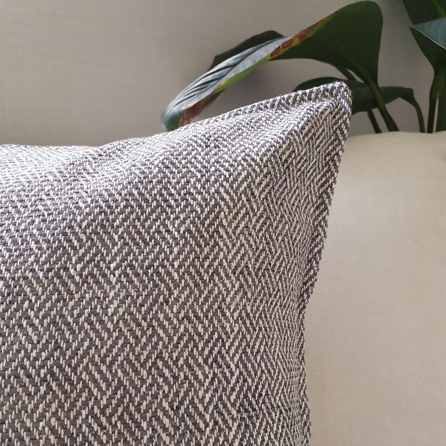 Brunswick cushion cover in colour storm on a sofa in the living room