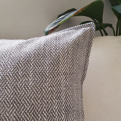 Brunswick cushion cover in colour storm on a sofa in the living room