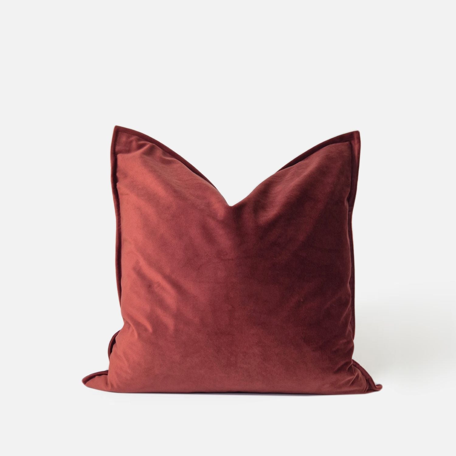Red velvet cushion, front view on a white background