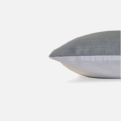 blue plain woven cushion, side view on a white background