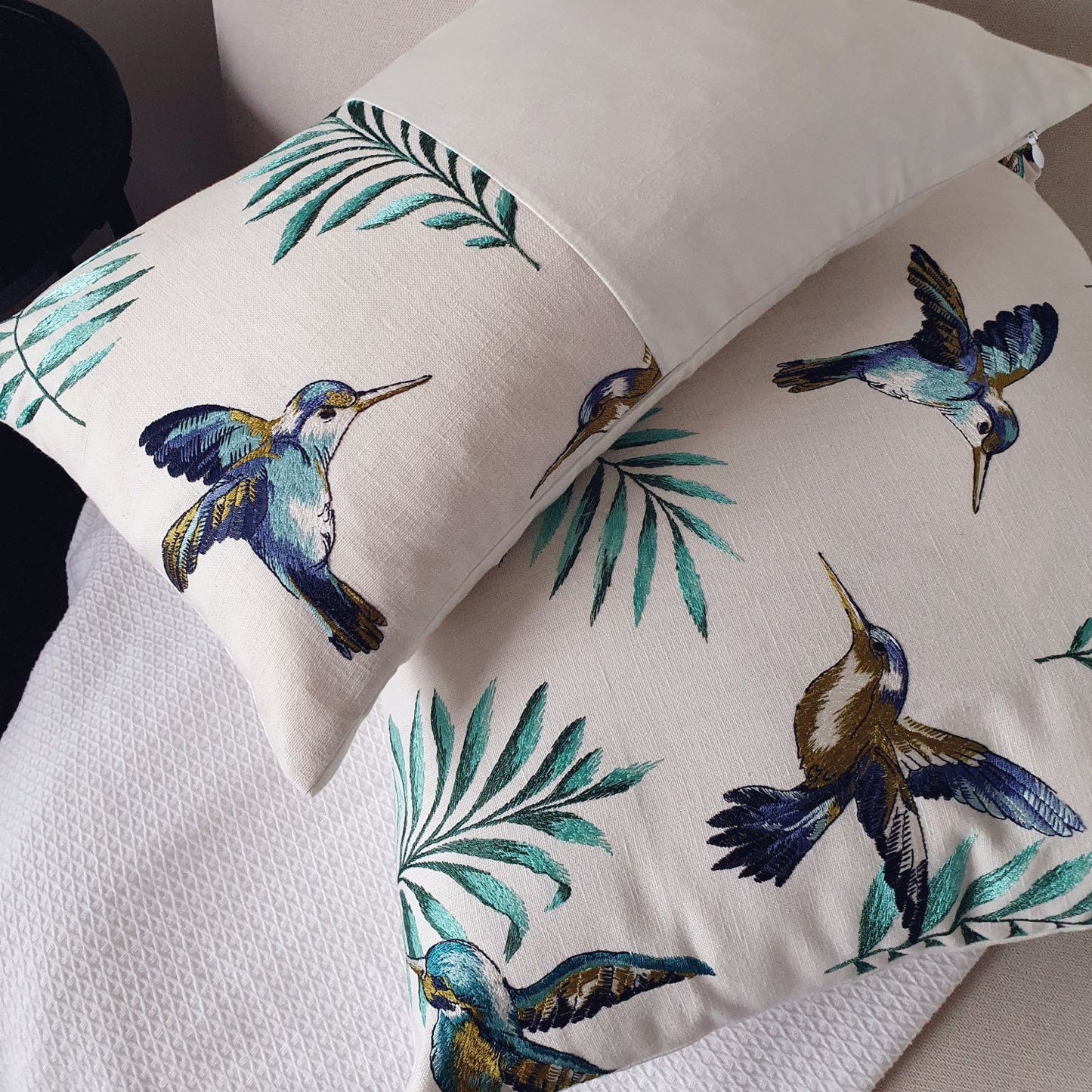 Avian Ivory embroidered cushion styled in a dreamy, sophisticated New Zealand living room setting for a high-end designer look.