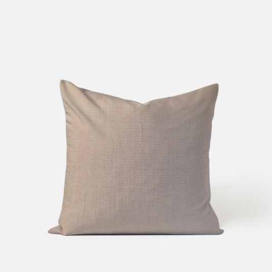 antique beige woven cushion with pattern, front view on a white background
