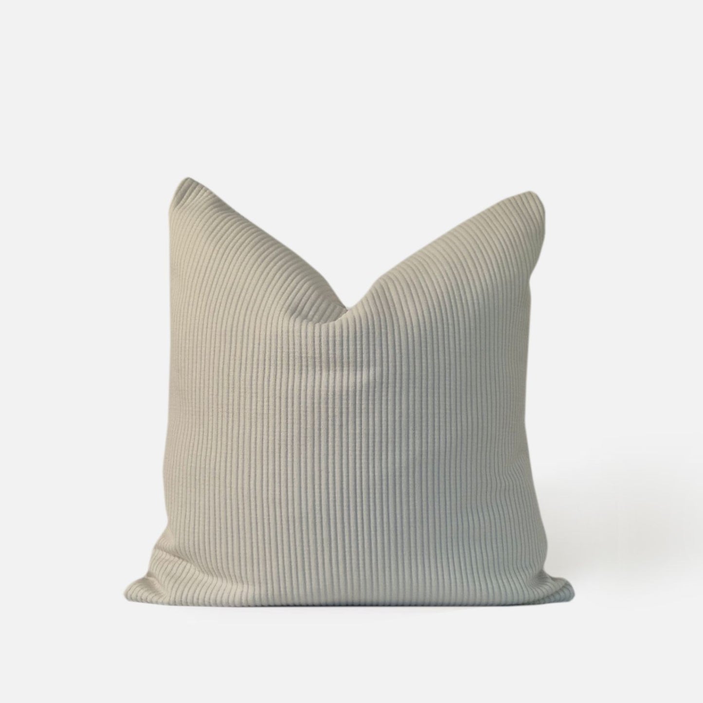 cream textured cushion with ribbed pattern, front view on a white background