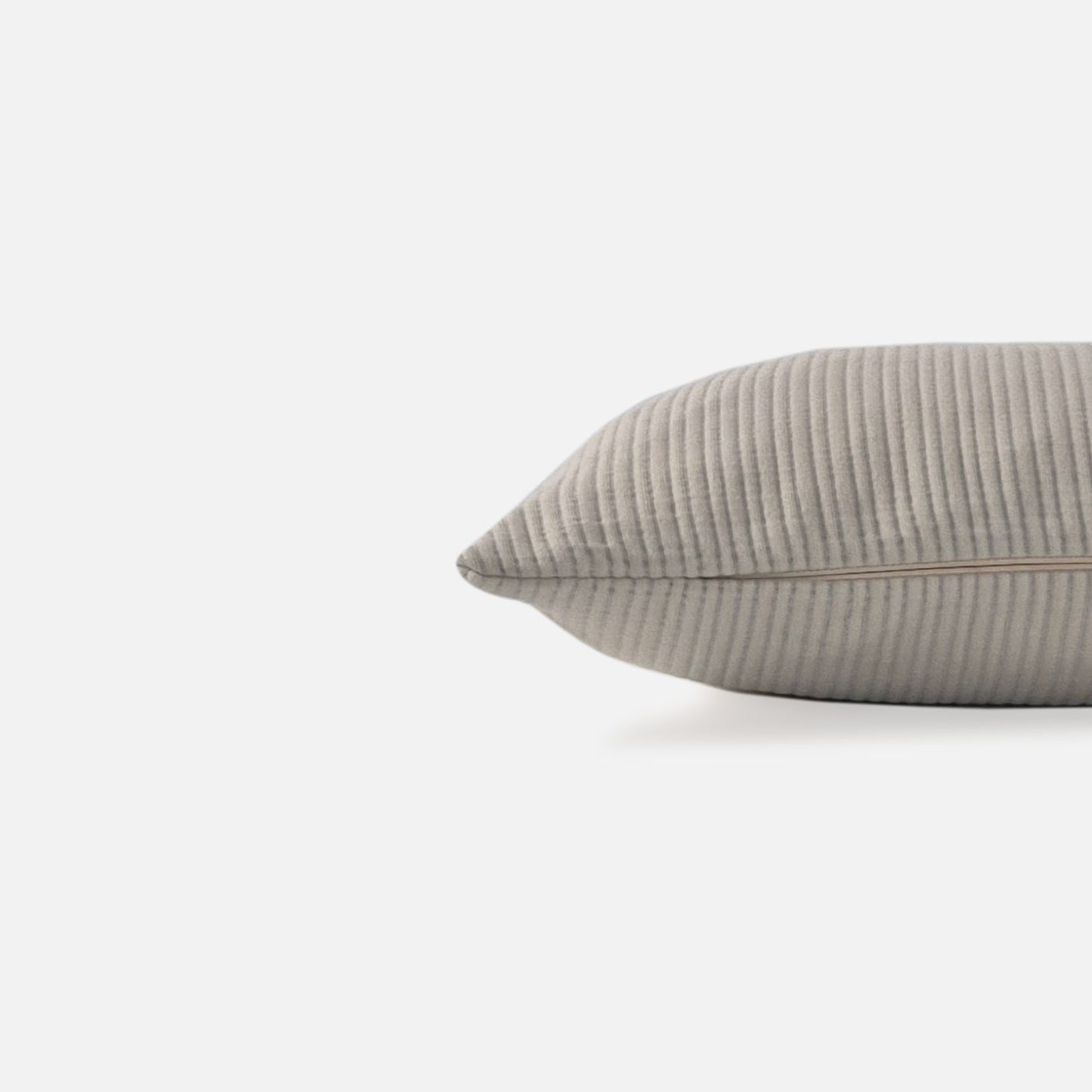 cream textured cushion with ribbed pattern, side view on a white background