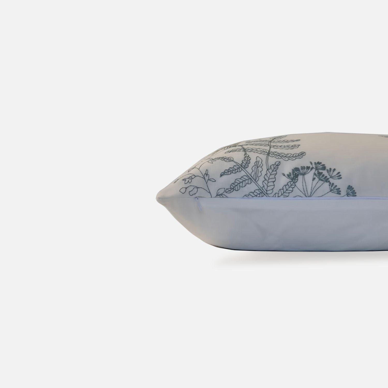 Elysian cushion with bird and plant embroidered pattern, side view on a white background