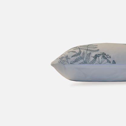 Elysian cushion with bird and plant embroidered pattern, side view on a white background