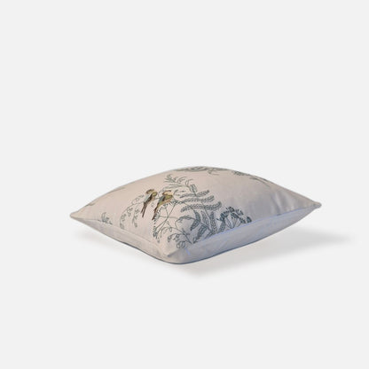 Elysian cushion with bird and plant embroidered pattern, top view on a white background