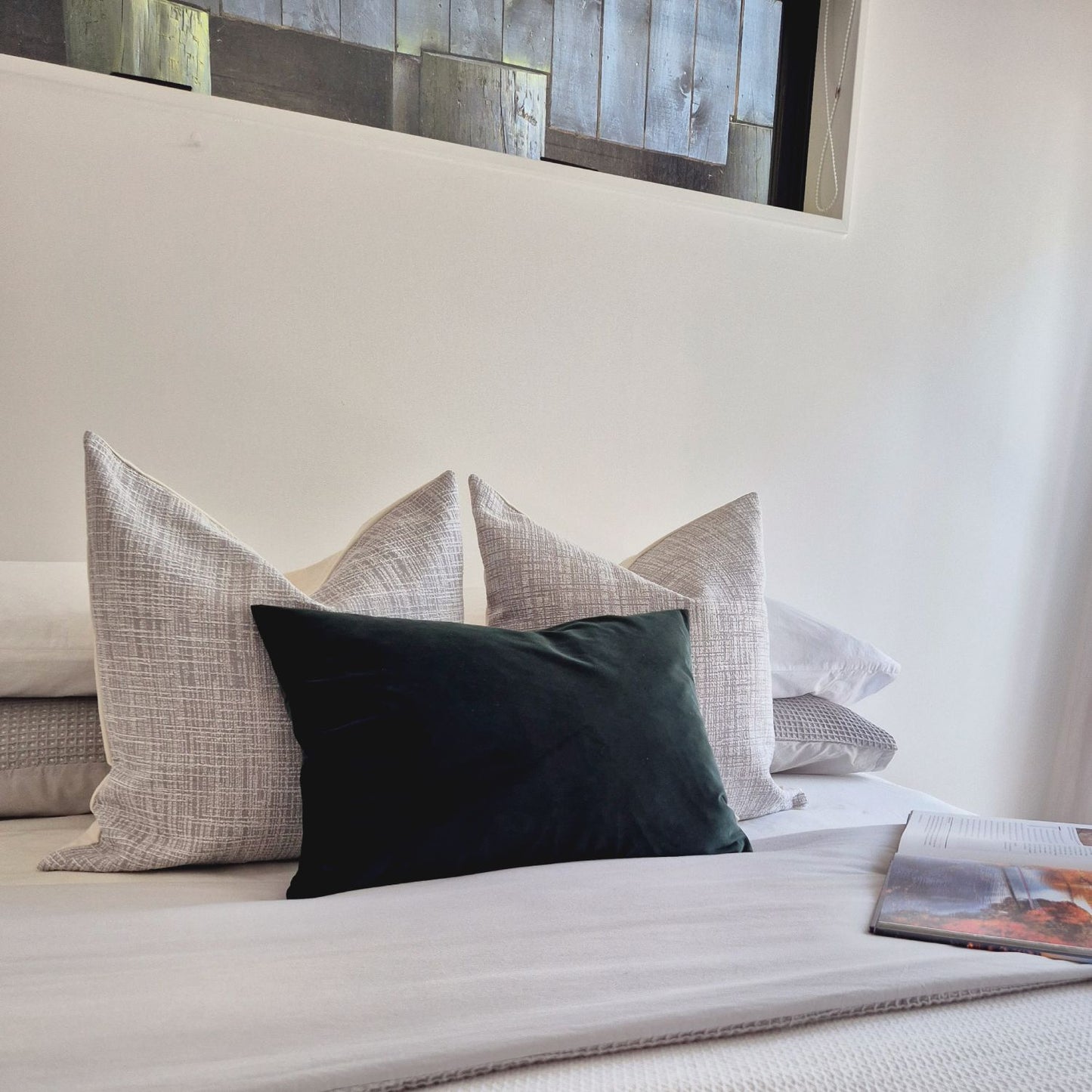 Decorative Threads Emerald Dusk cushion cover combo on a bed with neutral background.  Trio of Velvet and dual textured Covers in Smoke and Emerald.