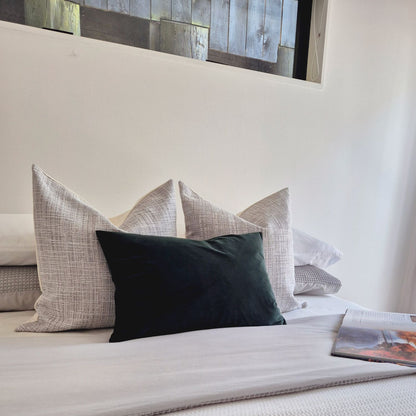 Decorative Threads Emerald Dusk cushion cover combo on a bed with neutral background.  Trio of Velvet and dual textured Covers in Smoke and Emerald.