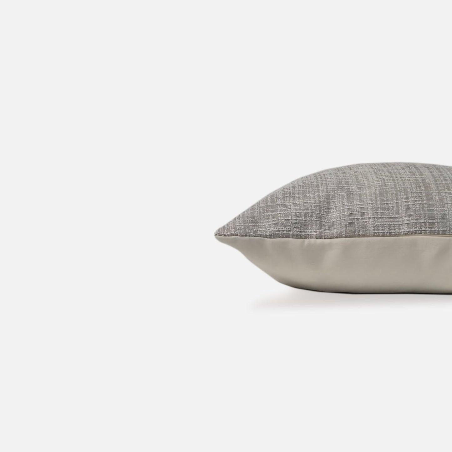 Decorative Threads Grey textured cushion, side view on a white background.