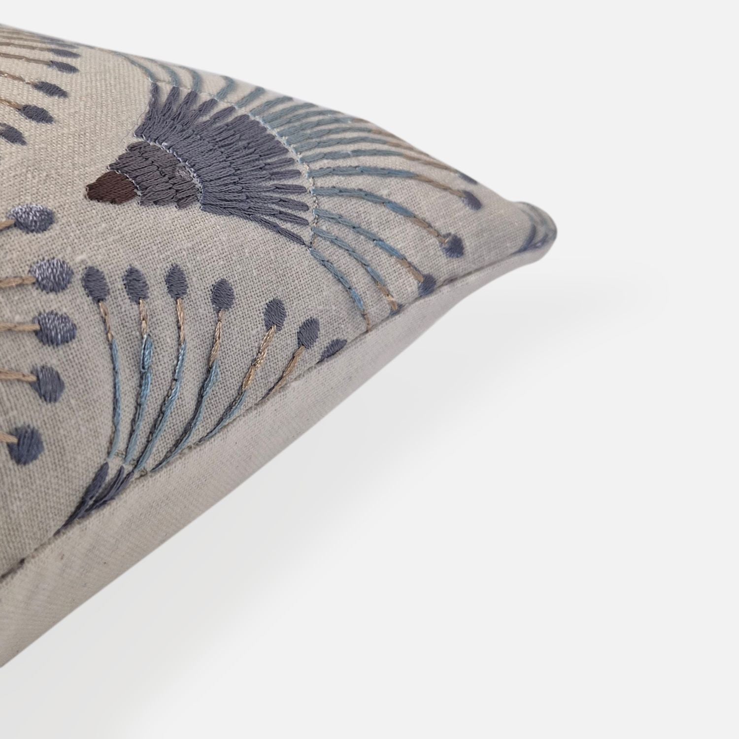 Decorative Threads Fanciful cushion cover in natural/indigo, corner view on a white background