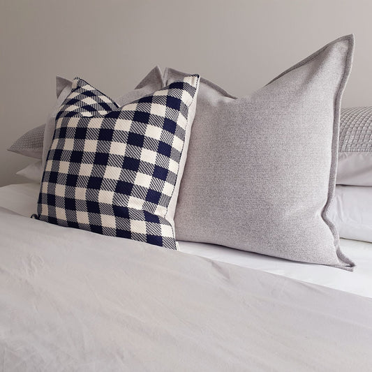 frankie ink and hutt cushion covers on a well made bed