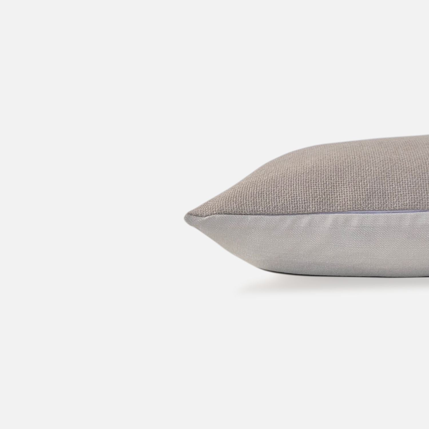 Decorative Thread Ida cushion cover in oatmeal with a woven texture, side view on a white background