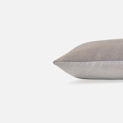 Decorative Thread Ida cushion cover in oatmeal with a woven texture, side view on a white background