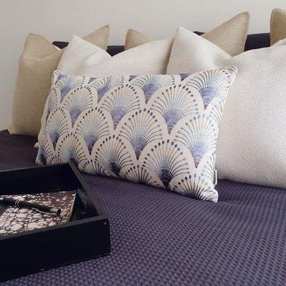 Decorative Threads neutral and embroidered cushions on a bed. Featured Katama, Ida and fanciful. 