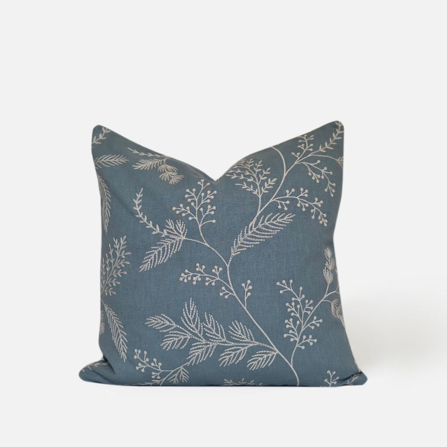 Decorative Threads Medley cushion cover in dusty turquoise with a embroidered botanical design, front view on a white background