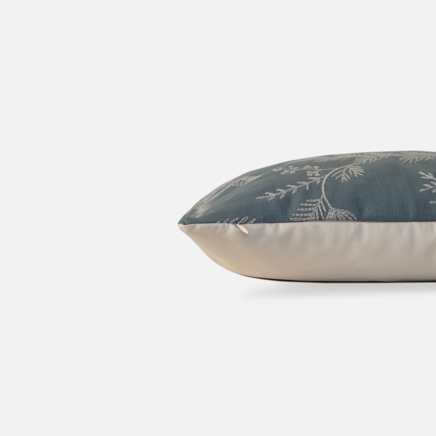 Decorative Threads Medley cushion cover in dusty turquoise with a embroidered botanical design, side view on a white background