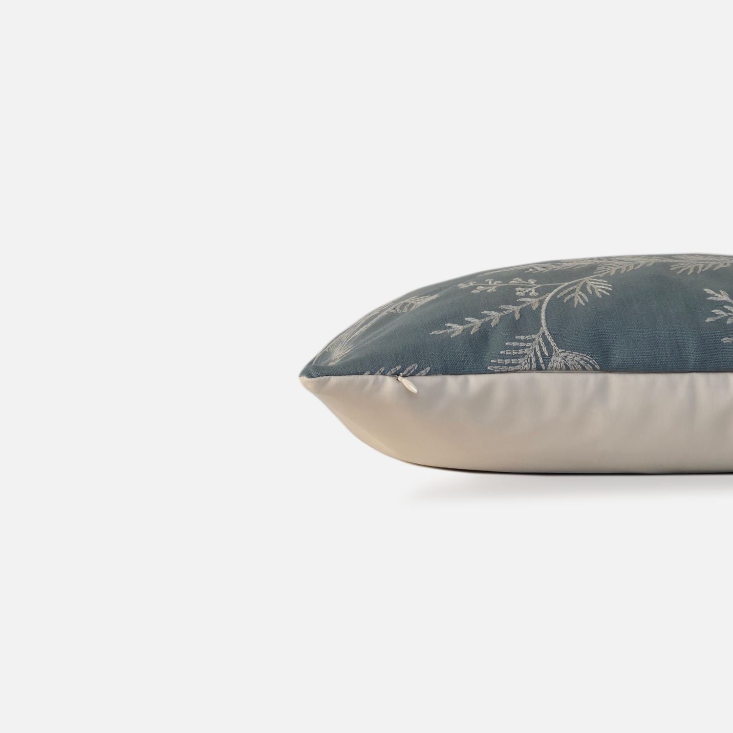 Decorative Threads Medley cushion cover in dusty turquoise with a embroidered botanical design, side view on a white background