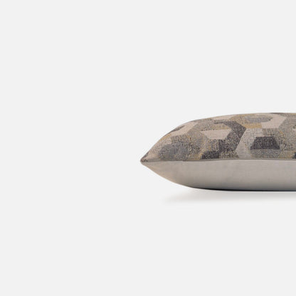 Side view of a neutral geometric cushion cover with woven textured detailing.