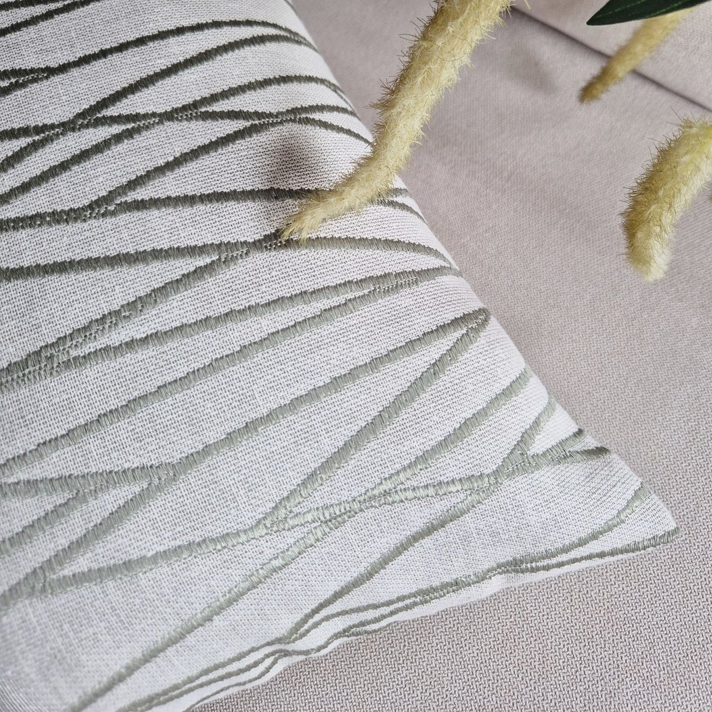 Decorative Threads Meadow textured cushion with leaf pattern on a neutral background.