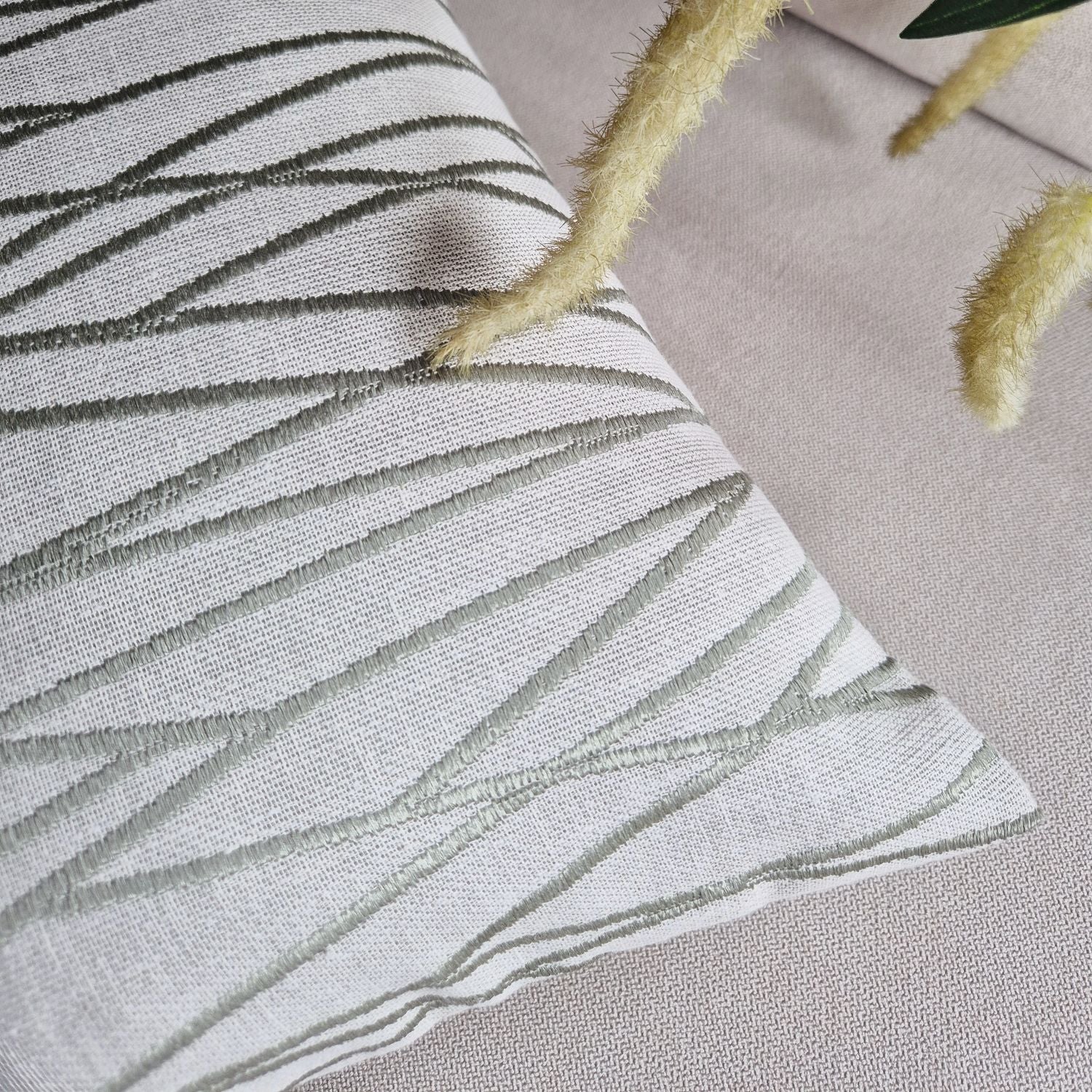 Decorative Threads Meadow textured cushion with leaf pattern on a neutral background.