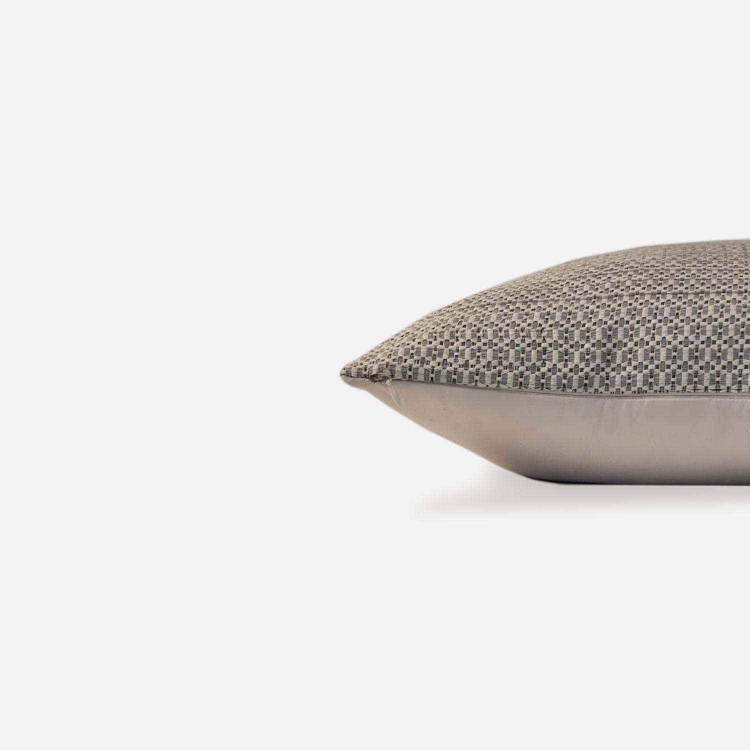 Decorative Threads Textured cushion with a geometric pattern, side view on a white background.