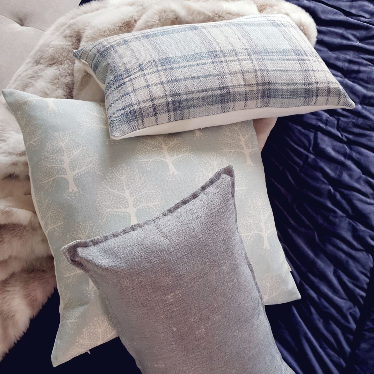 Decorative Threads Oak Cushion with different patterns on a textured surface.