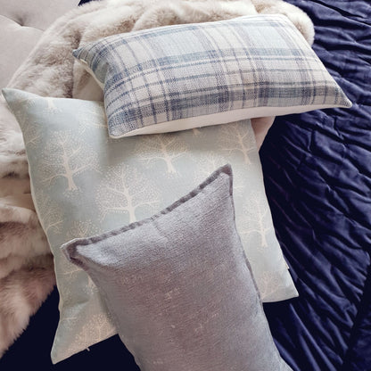 Decorative Threads Oak Cushion with different patterns on a textured surface.